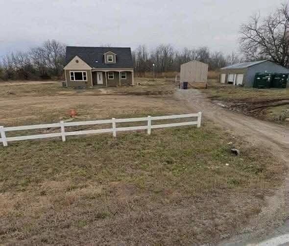 Incredible Real Estate Opportunity: Spacious 4-Bedroom Home on Expansive Acreage in Augusta, Kansas with Detached Garage and Endless Outdoor Potential